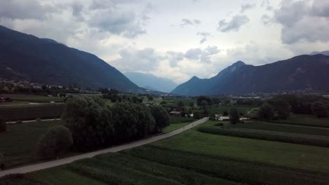 Aerial-panoramic-view-of-Levico-Terme,-Italy,-during-sunrise-with-views-of-the-mountains