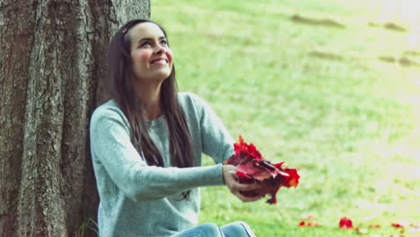 Brunette-woman-in-slow-motion-throwing-maple-leafs