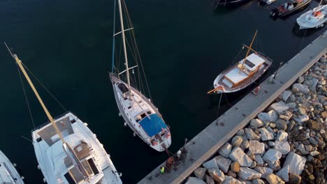 Stunning-shot-of-a-sailing-yacht-docked-in-the-beautiful-island-of-Paros,-Greece-during-summer