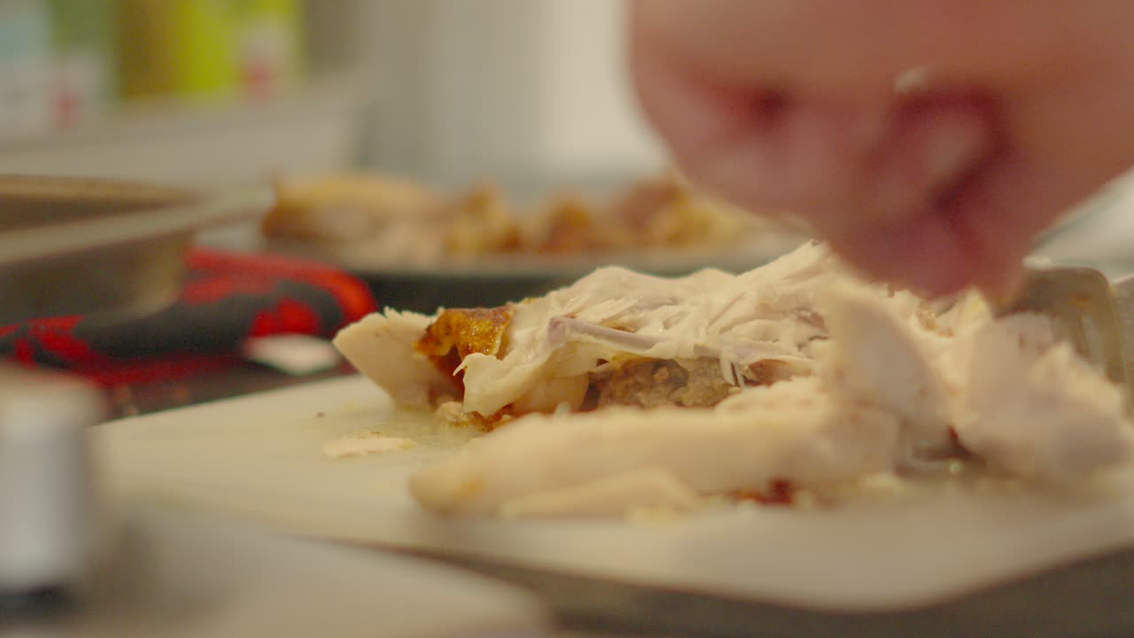 Whole Chicken Pieces Being Cut Up into Small Chunks on Chopping Board. Lean Protein Roasted Meat Being Prepared After Cooking