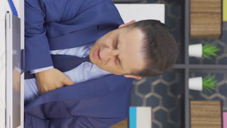 vertical video of businessman having a heart attack.