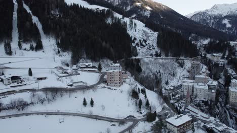 drone view of mountain hotel in snowy landscape in austria frozen landscape