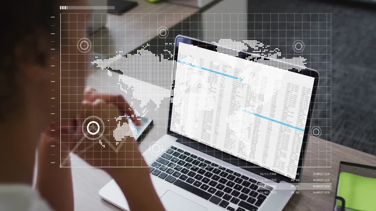 Analyzing data with world map and graphs overlay, person using laptop