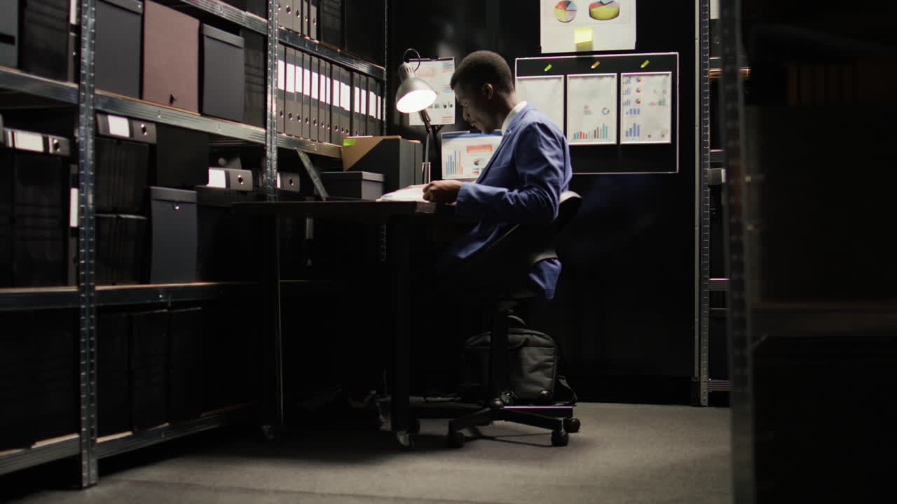 Team Working in a Dark Office with Shelves and Documents