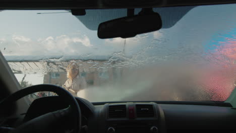 a woman washes her car in a self-service sink 4