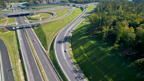 drone dolly tilt up flies along highway offramp to gdynia wielki kack, poland