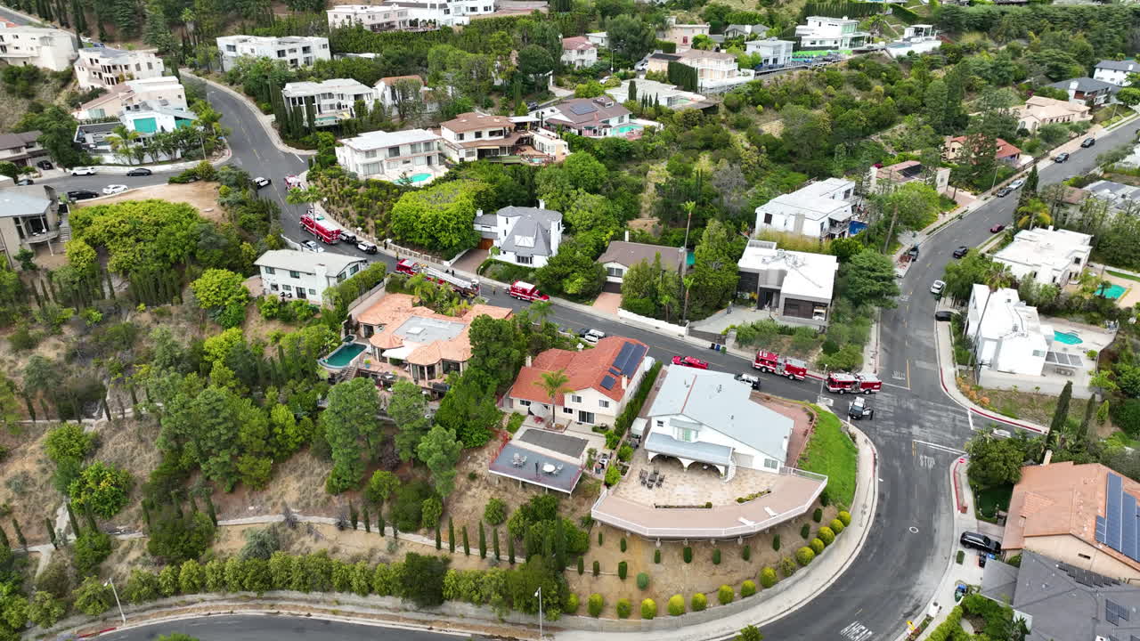 Drone shot of fire trucks in a upscale suburb of Los Angeles, daytime in USA