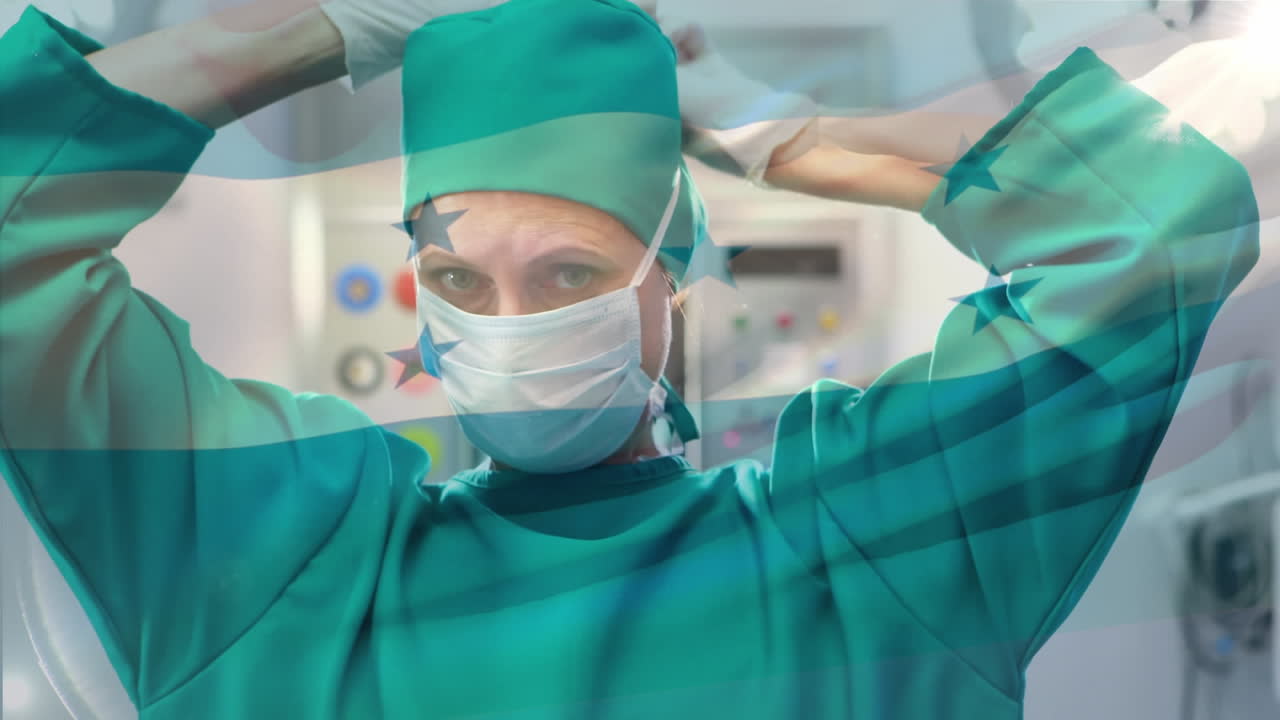 Animation of flag of honduras waving over female surgeon in operating theatre