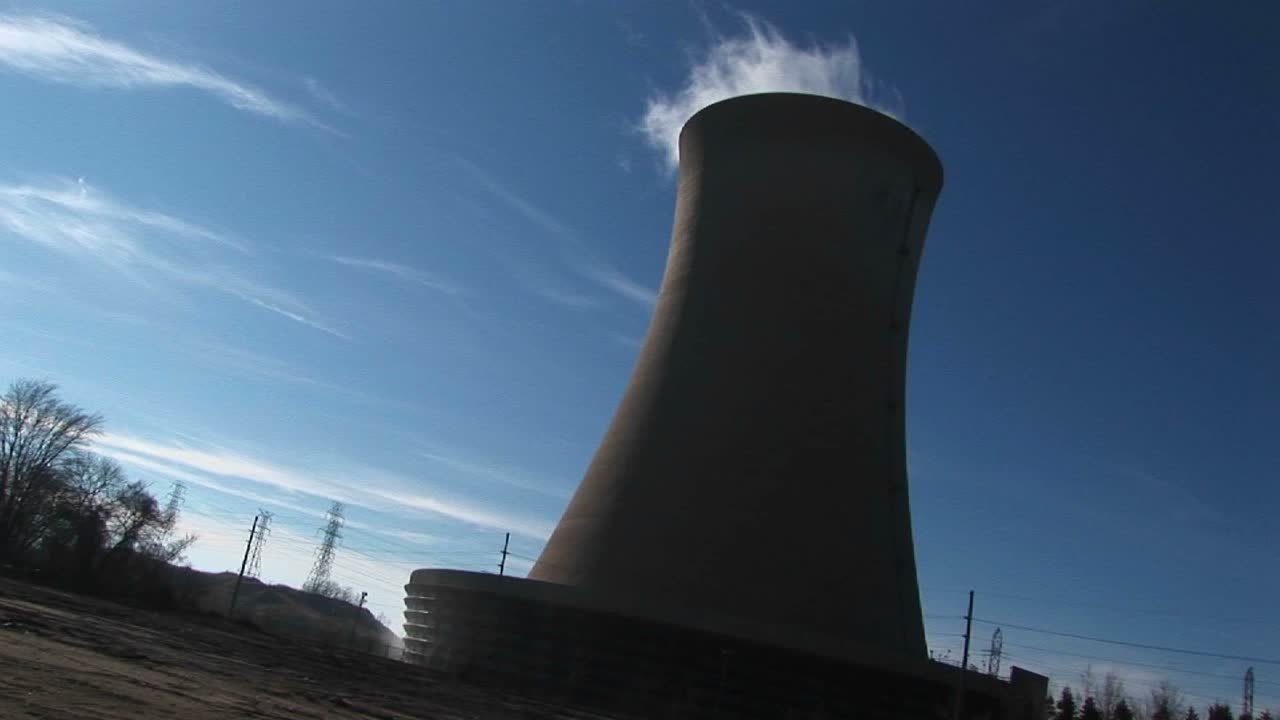 el vapor se eleva desde la parte superior de una planta de energía nuclear en este tiro inclinado