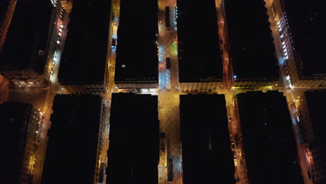 Aerial-overhead-top-down-birds-eye-night-view-of-house-rooftops-in-urban-city-center-of-Lisbon,-Portugal