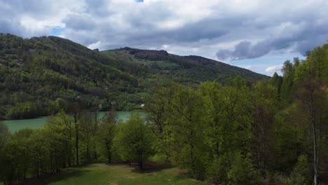 drone shot reveal turquoise lake at mountain