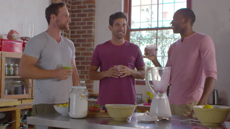 three male friends with homemade smoothies talking in kitchen, shot on r3d