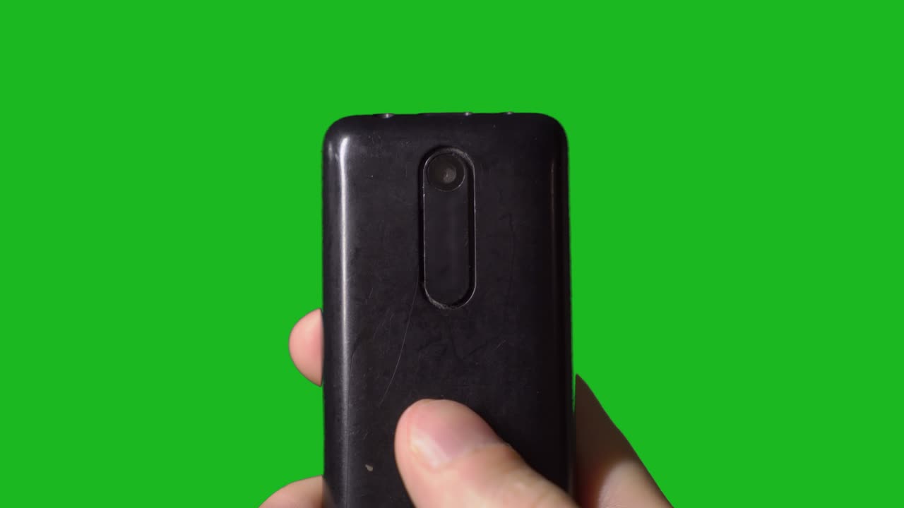 오래된 빈티지 휴대전화를 사용하는 사람. 버튼이 있는 셀러의 카메라 렌즈