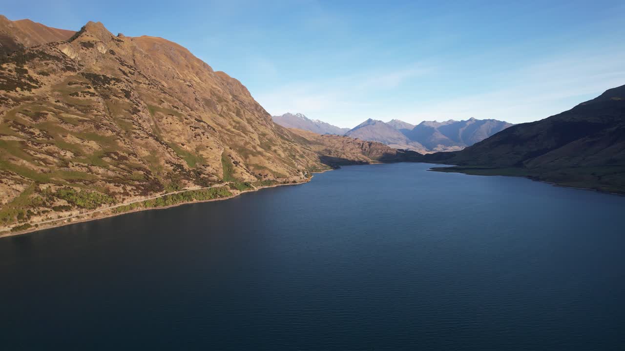 Lake Hawea With Calm Water And Scenic Mountain Views In Summer In South Island, New Zealand. - aerial shot