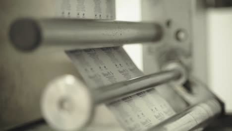 labels being printed and applied in pharmaceutical packaging at production line.
