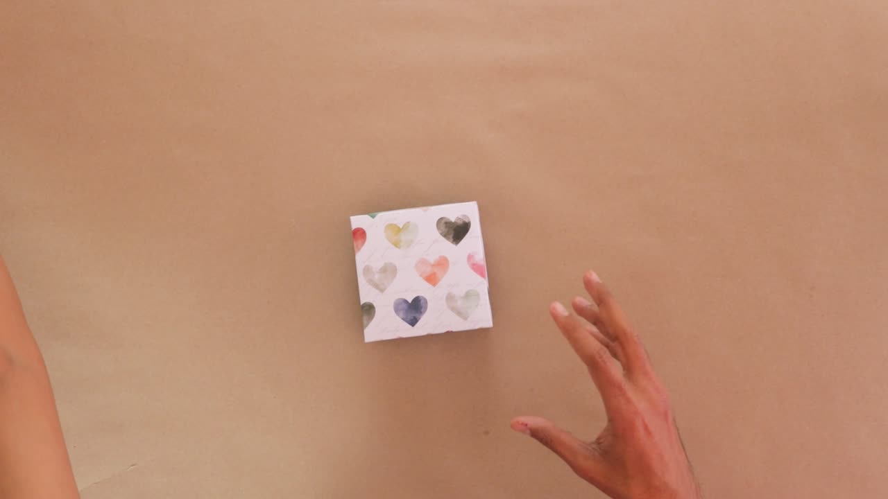 Opening Valentines day cardboard gift boxes with folded paper inside.