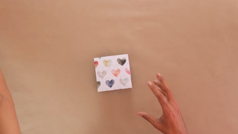 opening valentines day cardboard gift boxes with folded paper inside.