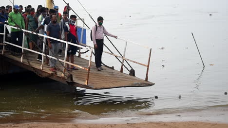 a ferryboat arrived on jetty or dock with full of passengers starting to departure on platform video background in pro res 422 hq