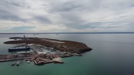 Aerial-panorama-view-of-the-beautiful-Playa-Pichilingue-near-Pichilingue-port-of-La-paz-in-Baja-California,-Sur-Mexico-with-calm-sea-and-rocky-landscape-with-cloudy-sky