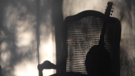 silhouette of a banjo on a chair, soft shadows.