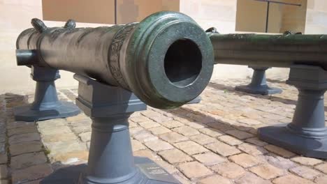 pan of battle scared historical european artillery cannons on display at an army museum