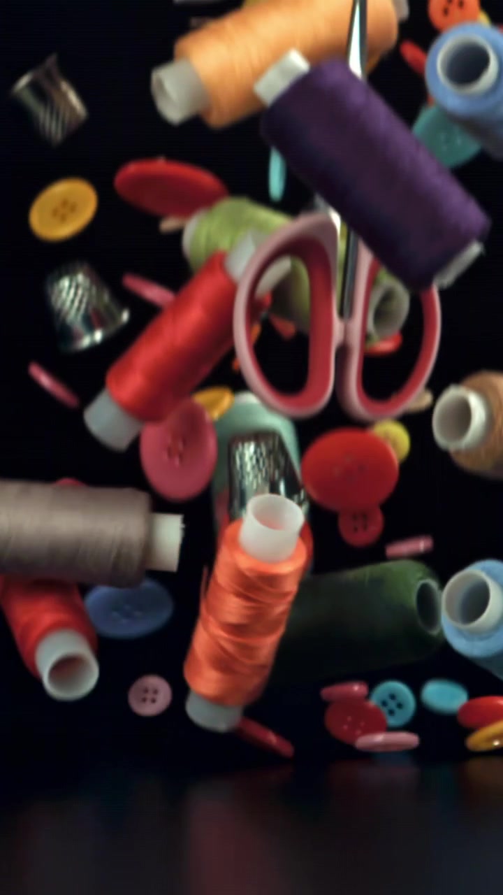 Colorful Sewing Supplies and Buttons Falling in Slow Motion