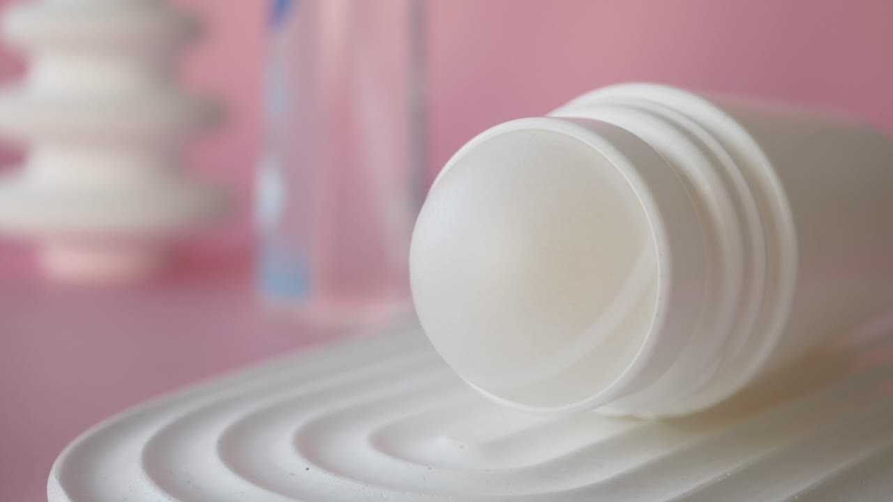White Roll-on Deodorant Close-up on Pink Background