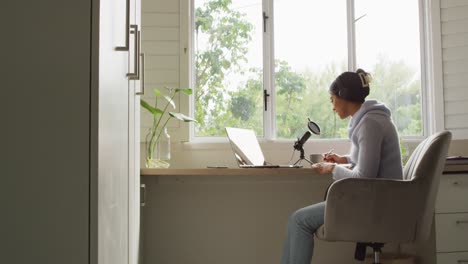 Video-of-biracial-woman-taking-part-in-online-interview-on-laptop-at-home