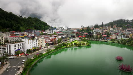 scenic drone flight over sapa lake in touristic hill tribe alpine town, vietnam