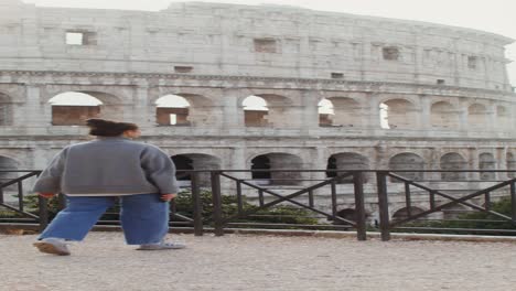 woman in front of the colosseum in rome