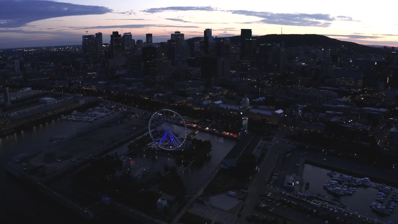 Aerial shot of Montreal's Old Port with the Ferris wheel in view, showcasing the vibrant waterfront and historic architecture. Perfect for capturing the essence of the city.