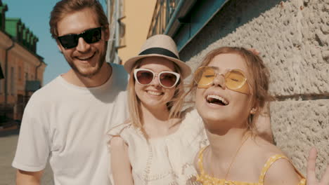 three friends posing in a city street