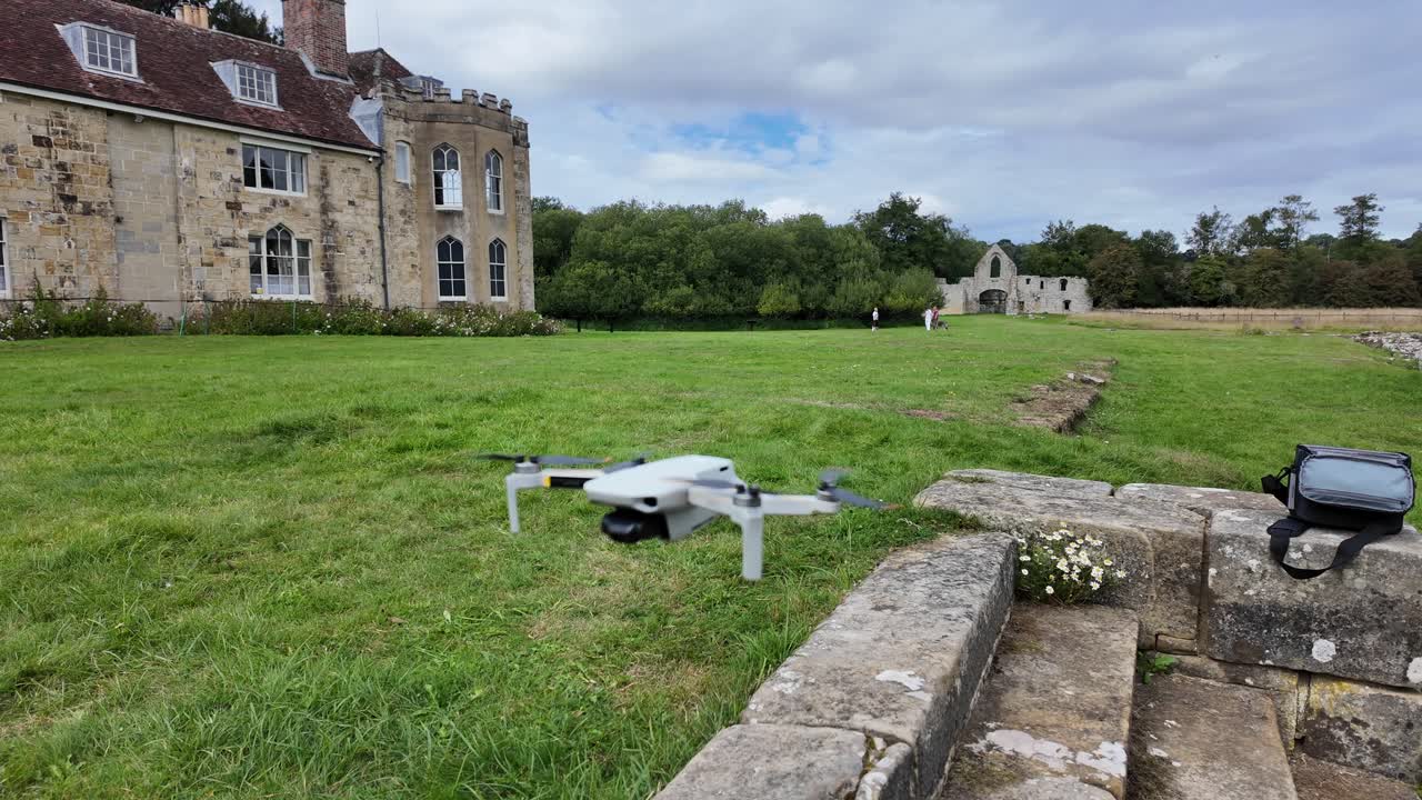 Close-up aerial view of a drone hovering in front of the Dower House at Old Bayham Abbey, Kent. Historic architecture and surrounding countryside, ideal for travel or cinematic projects