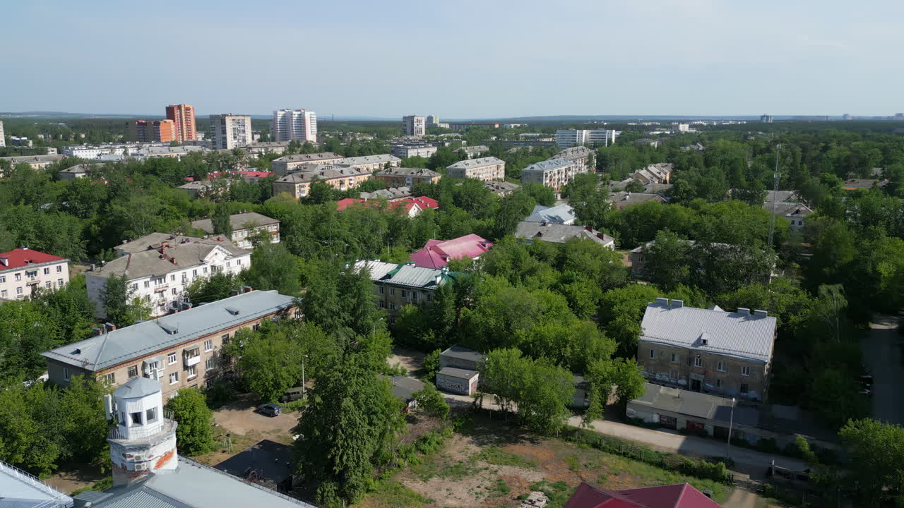 Aerial View of a Green Urban Landscape with Residential Buildings and Trees