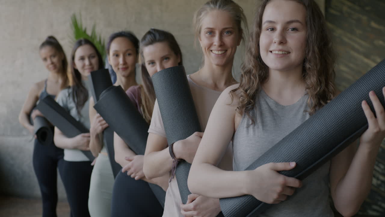 Women holding yoga mats
