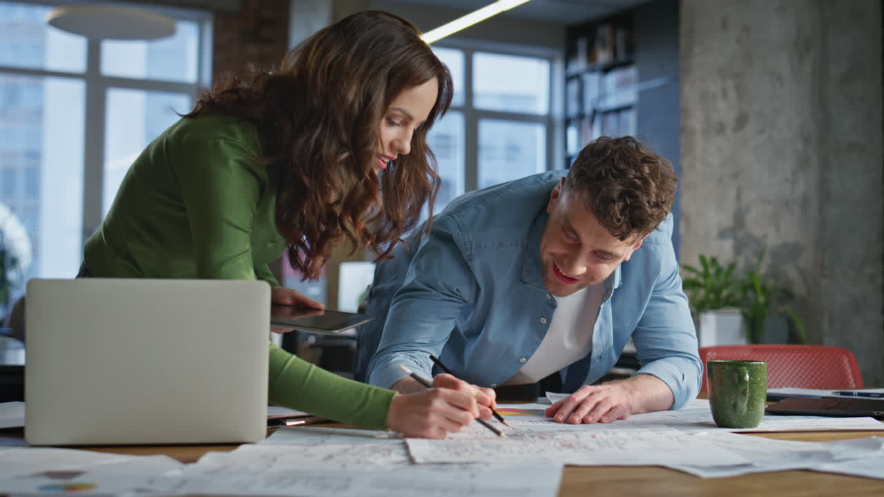 Happy coworkers drawing blueprint open space office closeup. Partners creating