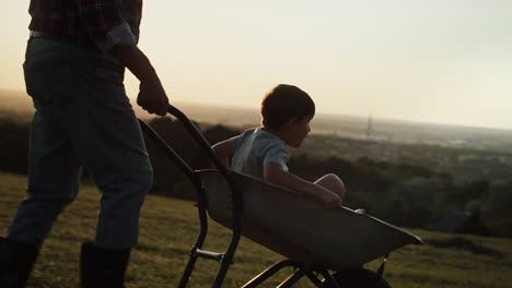 video of boy having fun during driving on a wheelbarrow