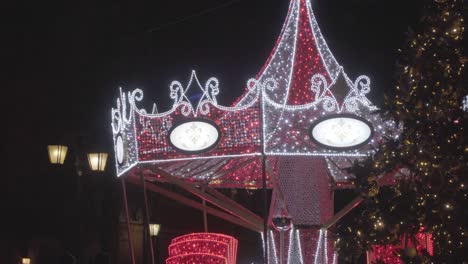 closeup shot to merry-go-round lightened at night in neon lights, warsaw poland