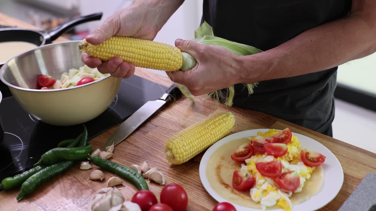 Preparing a Meal with Corn and Vegetables