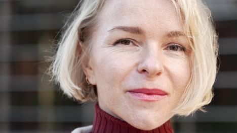 close up portrait of elegant stylish blond woman looking to the camera