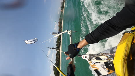 pov vertical gopro, person kite surfing doing acrobatic tricks on ocean