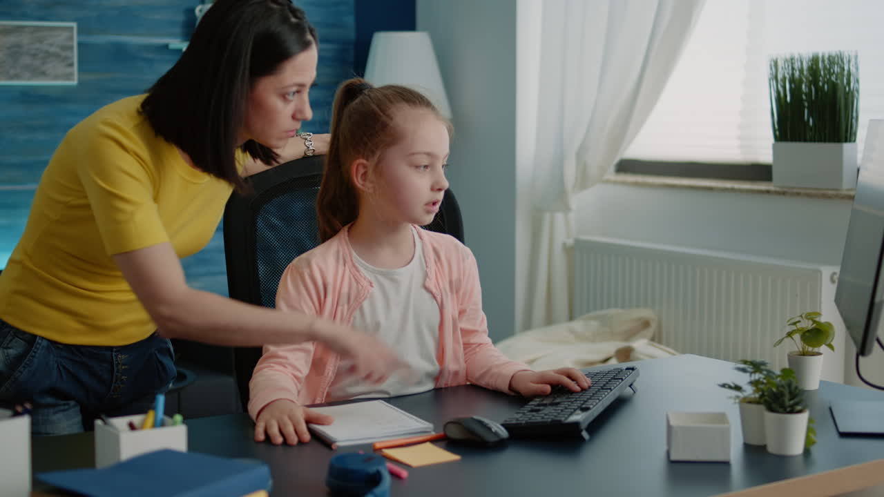 Mother helping young child with homework for remote education