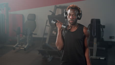 man lifting dumbbells in gym