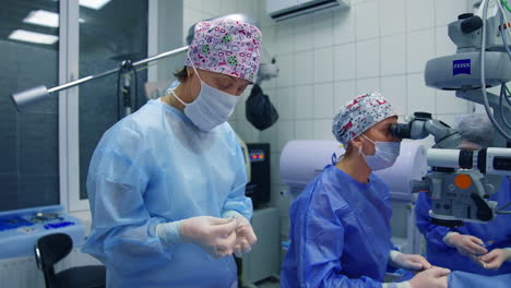 patient under surgical microscope. doctor with assistants doing eye surgery with modern microscope at the hospital
