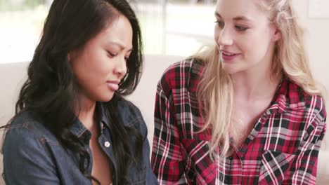 young woman comforting her friend