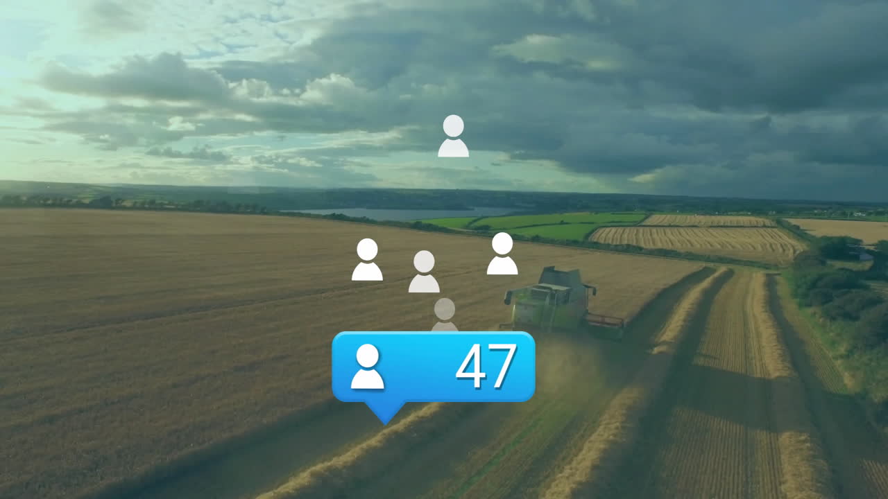 Green combine harvester moving through harvested field, showing social icons and follower badge
