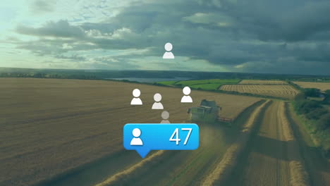 green combine harvester moving through harvested field, showing social icons and follower badge