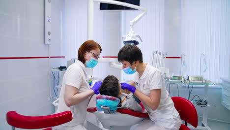 young boy at dentist office. little boy sitting in the dentist chair