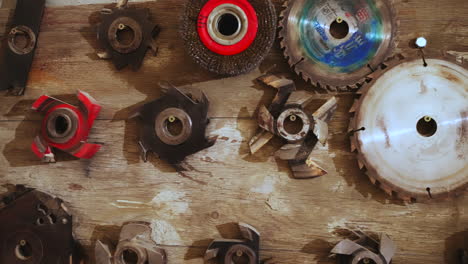 collection of woodworking and cutting tools on a wooden surface