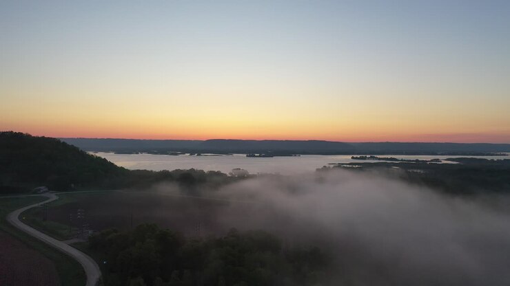 Sunrise over a misty river valley